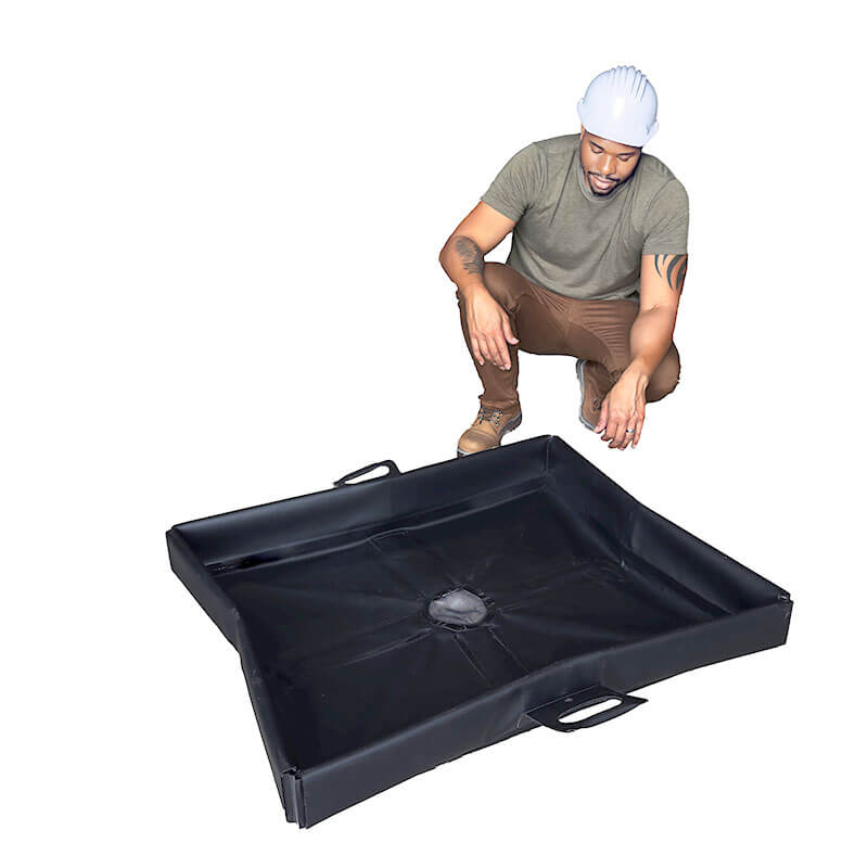 A man wearing a hard hat, green t-shirt, and brown boots crouches next to the UltraTech Pellet Pond 8859, a black containment tray with raised edges and handles, by UltraTech, set against a white background.
