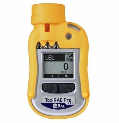 A RAE Systems ToxiRAE Pro LEL gas detector in yellow, built for accurate detection of combustible gases, shows "0% LEL" on its screen. Below the display are two buttons, and above it is a sensor opening.