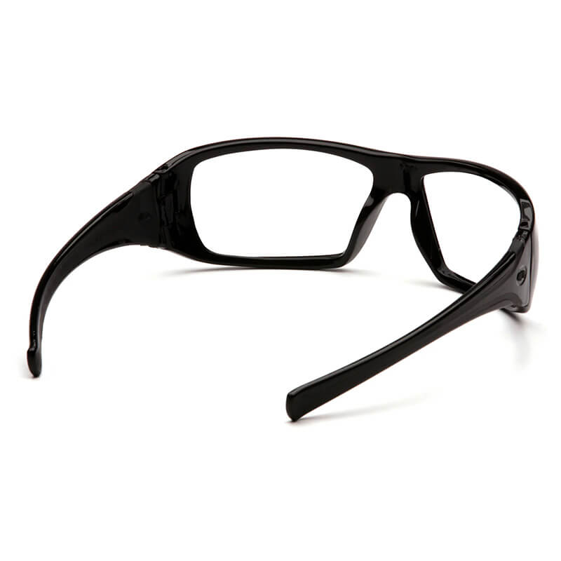 The Pyramex Goliath Safety Glasses, featuring black frames with clear lenses and wraparound arms, are displayed as a perfect addition to your workwear ensemble. Designed by Pyramex Safety, their sleek and solid frame offers optimal eye protection.