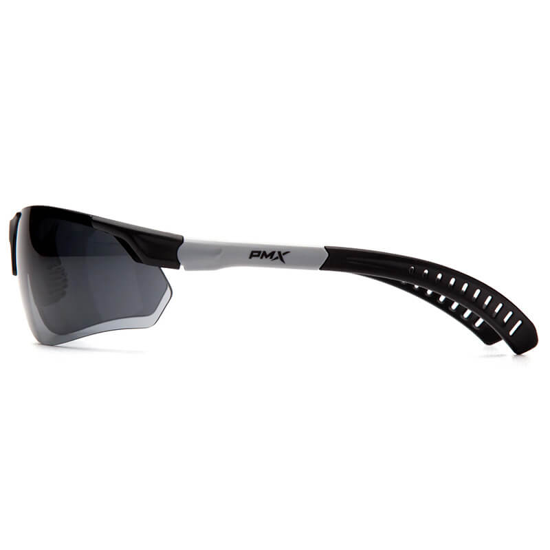 Side view of Pyramex Sitecore Safety Glasses SBG101_0DTM by Pyramex Safety, featuring a sporty black and white wraparound frame, dark tinted lenses with anti-fog coating, ventilated temple arms, and the "PMX" logo on the side.