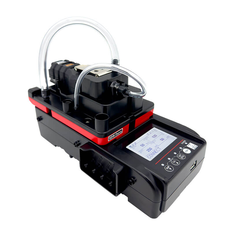 The RKI SDM-Force Calibration Station, sleek in black and red with a clear tube, features a digital display and control buttons. Its compact design ensures portability for easy bump testing and use at any calibration station.