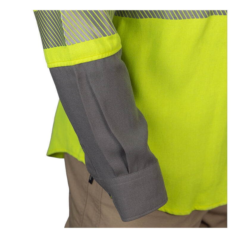 A person wears the NSA DRIFIRE FR Hi-Vis Lightweight Work Shirt Class 3 SHRTS1C3. The high-visibility yellow shirt has reflective stripes and Inherent FR Protection, with a gray right sleeve rolled up to display its Moisture Wicking properties. It's paired with beige pants for comfort and safety.