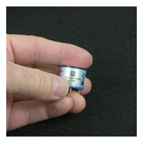 A hand holds a Replacement O2 Sensor for GasAlert Monitors SR-X2V by BW Technologies (Honeywell), showing three gold pins, a QR code, and printed text on its surface, set against a black background.