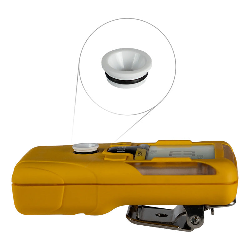 The image shows a yellow handheld WatchGas device featuring a digital display and a round white button, highlighted in an inset that zooms in on the white cap with a black rim. Designed for gas monitor sensor protection, the device is clipped and angled to the left, ensuring reliable performance when used with WatchGas SST1 External Filter for Fine Particles or other SST1 accessories.