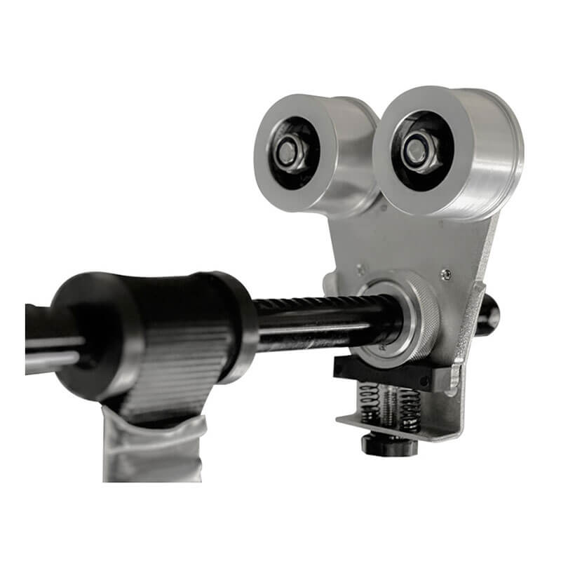 Close-up of the Frontline Beam Trolley Anchor by Frontline Fall Protection, featuring a metal cable pulley system and dual round rollers on a bracket, attached to a textured grip handle; fits 3"-10" wide I-beams.