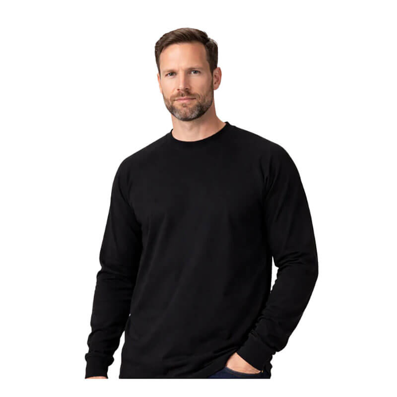 A man with short brown hair and a beard stands against a white background, wearing the ForgeFR Forge FR Crew Neck Tee MFRCNT-009. With his left hand in his pocket, he displays protective workwear in a simple, timeless style.