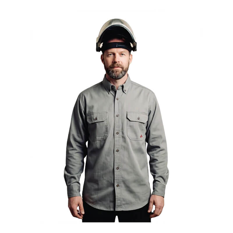 A bearded man wearing the ForgeFR Forge FR Solid Button Shirt MFRLB2PS024 in light gray with chest pockets faces forward. He has a clear safety helmet with a black band, and the background is plain white.