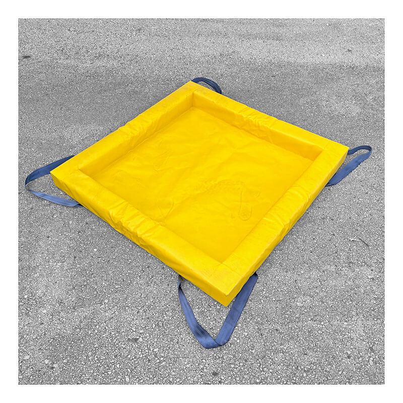 A yellow, square UltraTech Containment Berm - Foam Wall XC Model 898_ with raised edges and blue carrying straps sits on gray pavement. Designed for use by UltraTech, it performs well even in extreme cold conditions.