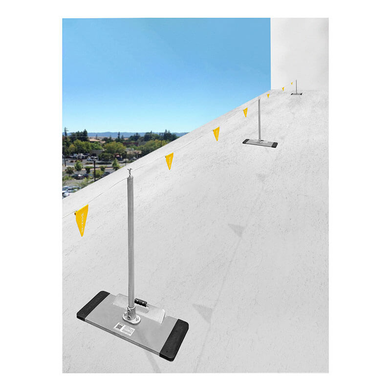 Frontline Fall Protection's Frontline Warning Line System with Base and Handle, featuring yellow warning flags, is installed in a row on a sloped white roof to help protect against fall hazards while overlooking a cityscape.