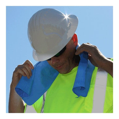 A construction worker, equipped with a white hard hat, sunglasses, and a vibrant yellow safety vest, adjusts a PIP EZ-COOL Cooling Towel 396-602-B made from Poly Vinyl Alcohol around their neck as the sun shines in the background.