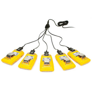 Five yellow pedal devices, resembling a BW GasAlert 5 Unit Charging Assembly from BW Technologies by Honeywell, connect by black cables to a single power source. Featuring metallic switches and structured design, they are arranged fan-like with cords extending outward and converging at the top.