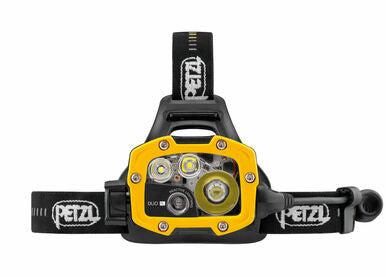 The Petzl DUO RL Rechargeable Headlamp (E103AA00) in yellow and black features multiple LED lights on a black adjustable strap, highlighting its REACTIVE LIGHTING® technology for optimal brightness. With a powerful output of 3000 lumens, it ensures excellent visibility, and the "Petzl" brand name is elegantly printed in white on the strap.