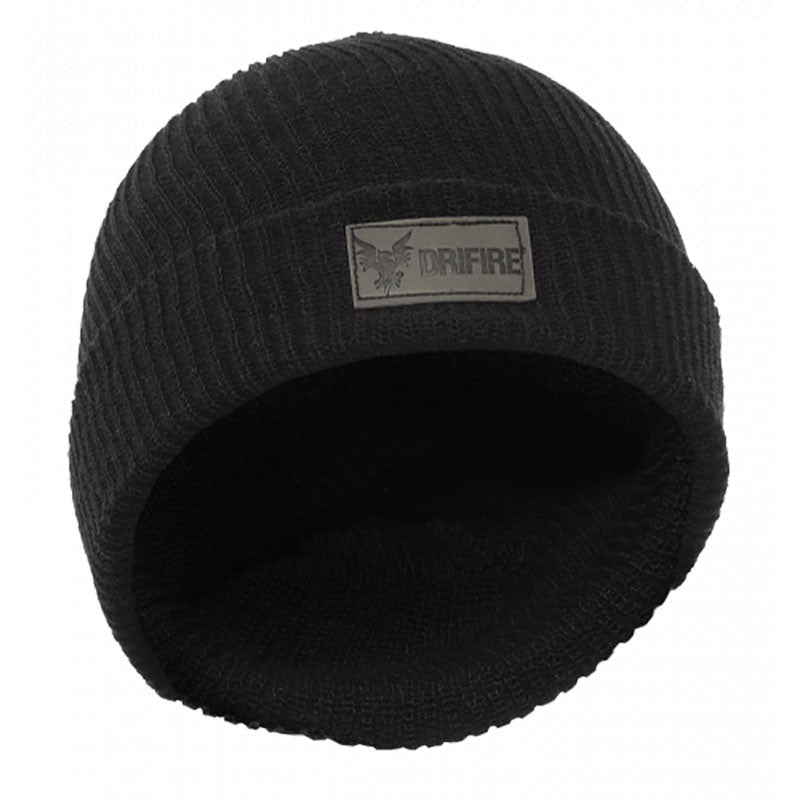 A black ribbed NSA FR Knit Winter Hat features a rectangular patch displaying an owl logo and the word "DRIFIRE" on the front. This flame-resistant winter hat is presented at an angle to emphasize its texture and design, merging style with safety.
