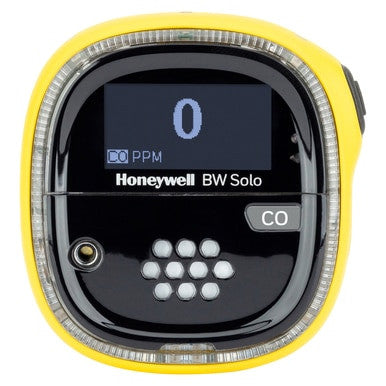 The Honeywell BW Solo Wireless Gas Detector CO BWS1-ML-Y, by BW Technologies, features a bright yellow casing. Part of the Safety Suite, its display reads "0 PPM," indicating no CO detected. The front shows a grid of white dots and a small sensor for efficient detection.