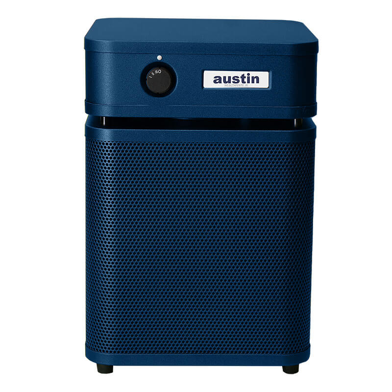 The Austin Air Systems HealthMate Junior Machine A200 is a blue rectangular HEPA air purifier with a control knob, “austin” branding, perforated lower section, and four feet—ideal for reducing allergies.