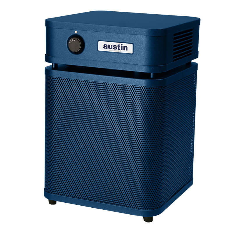 The Austin Air Systems HealthMate Junior Machine A200 is a blue HEPA air purifier with a black front control knob, perforated lower grille, and four feet—perfect for reducing allergies at home.
