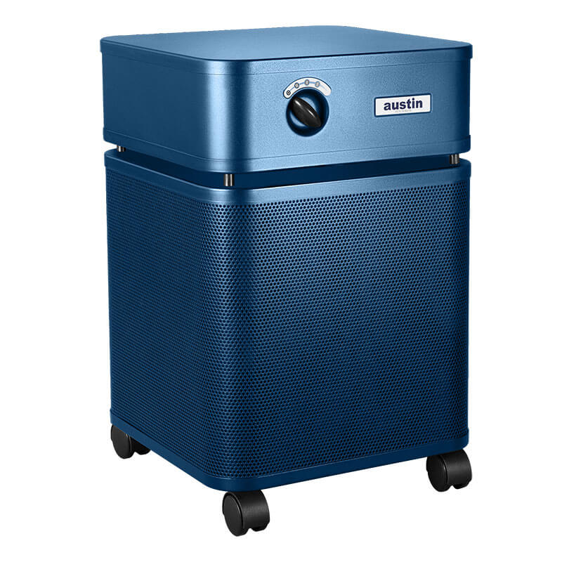 The Austin Air Systems HealthMate Plus Machine B450 is a blue rectangular air purifier with a control knob, medical grade HEPA for formaldehyde removal, a vented lower section, and four black caster wheels.