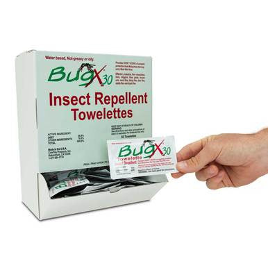 A hand pulls a single Coretex BugX30 Wall Mount Towelette from a white box labeled "Insect Repellent Towelettes," showing convenient mosquito protection with multiple Coretex packets visible inside. 50 towelettes per box, item 12644.