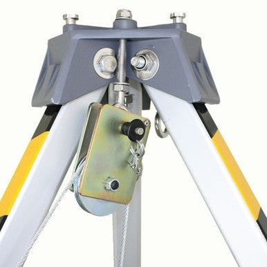 Close-up of a gray and yellow 3M Fall Protection tripod with a DBI-SALA Snatch Block Pulley 8003205 attached. Metal screws and bolts on the tripod provide stability and support, while the pulley, crucial for fall protection, is connected to a cable, indicating its use in lifting or securing equipment.