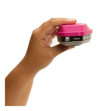 A hand holds a pair of 3M 60921 P100 Organic Vapor Filters by 3M, designed for respiratory safety and protection against organic vapors.