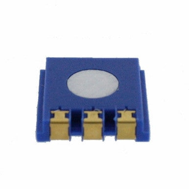 An up-close view captures a small, square electronic component that looks like the BW GasAlertMax XT II and MicroClip XT Replacement H2S Sensor SR-H-MC by PK Safety Supply. The sensor is designed with a blue casing, a circular white section on top, and three gold connectors visible on one side.