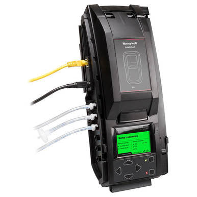 The BW IntelliDoX for Gas Alert Max XT II DX-MAXXT, similar in appearance to the Honeywell gas detector calibration device, includes multiple cables and a digital display for easy bump test readings. This sleek black calibration station features a visible BW logo and a network cable, effectively streamlining automated instrument management.