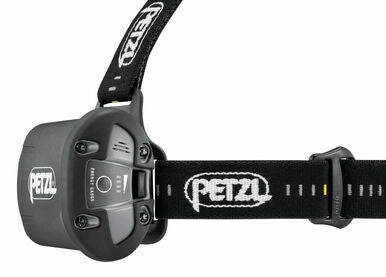 Side view of a black Petzl DUO RL Rechargeable Headlamp E103AA00, featuring an adjustable strap. This headlamp provides 3000 lumens and includes a button and branding on both the lamp and the strap. It is enhanced by REACTIVE LIGHTING® technology for optimal performance.
