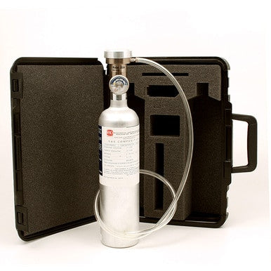 Displayed in front of an open black carrying case with custom foam padding, tailor-made for the RKI GX-2012 Calibration Kit by PK Safety Supply, is a silver gas cylinder featuring a pressure gauge and attached tubing. The case includes a handle on the right side to facilitate easy transport.