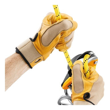 Hands wearing yellow and beige gloves tightly grip a yellow and black rope, threaded through the Petzl RIG Compact Self-Braking Descender D021AA00 by Petzl, which is likely used for climbing or safety harness purposes. The plain white background underscores the crucial importance of precision in rope access applications.