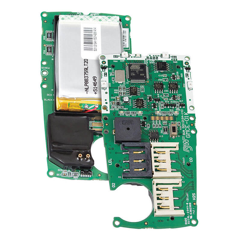 Close-up of a green circuit board from the BW Honeywell Replacement PCB kit for GasAlertMicroClip XL by PK Safety Supply, featuring various electronic components, including slots for SIM cards or memory, visible chips, connectors, and a replacement battery kit attached on the side.