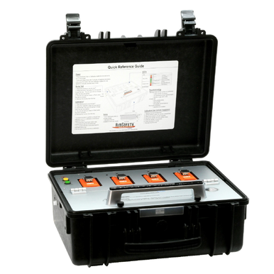 The AimSafety Single-Gas Monitor Calibration/Bump Test Station is a portable electronic device housed in an open black hard case with a handle. It features a control panel with buttons and switches specifically for calibrating PMR100R Gas Monitors. Inside the lid, there's an attached quick reference guide, making it perfect for on-the-go calibration or use as a Bump Test Station.