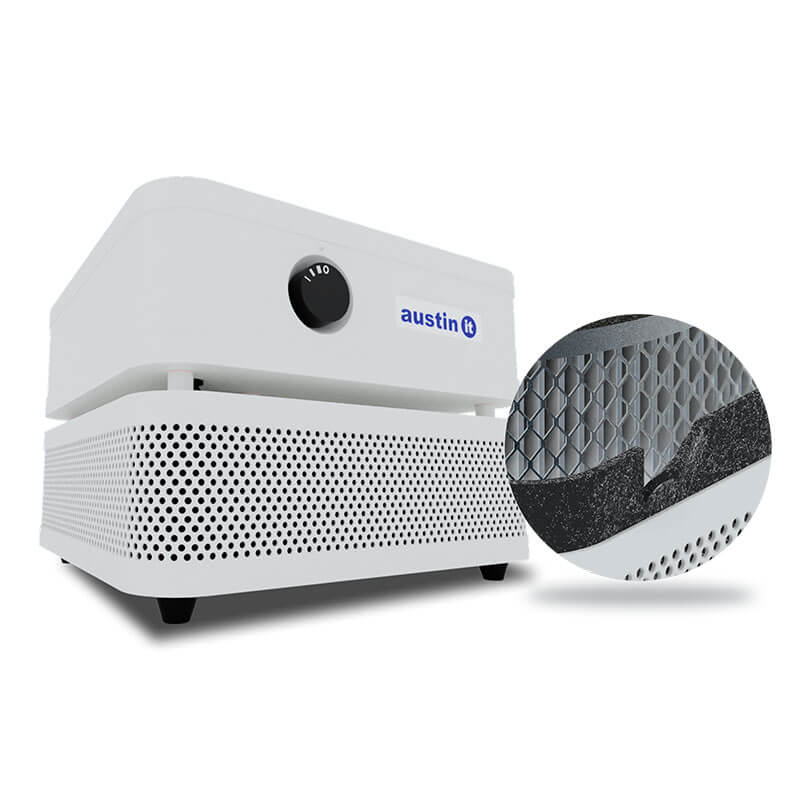 The Austin Air "it" Machine C100 by Austin Air Systems is a white, compact air purifier with a black control knob and black feet; a circular inset highlights its honeycomb filter and foam lining for efficient filtration of airborne particles.