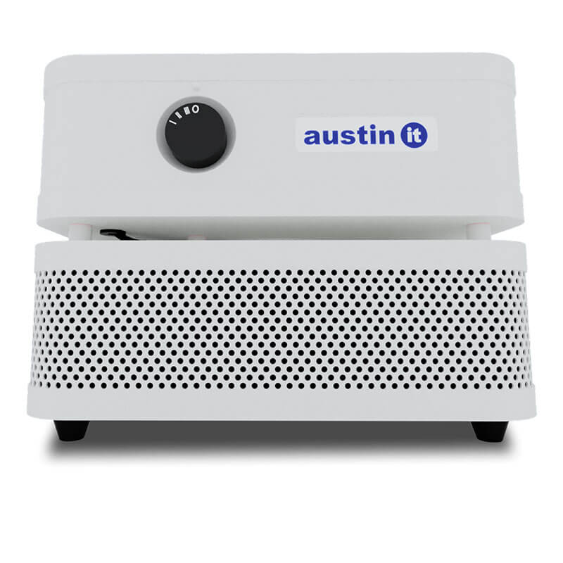 The Austin Air Systems "it" Machine C100 is a compact white air purifier with a front circular control knob, perforated lower air intake, and "austin it" label, designed for effective airborne particle removal.