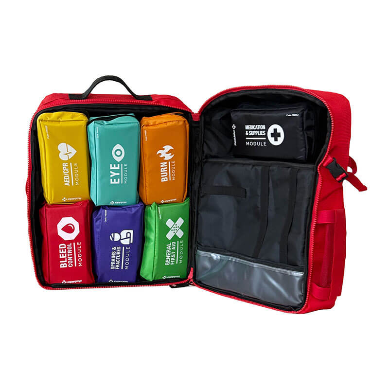 An open Aero Healthcare Modulator Trauma Backpack M600B reveals an ANSI Class B First Aid Kit with color-coded pouches for medication, bleeding, eye care, burns, CPR, wound care, and supplies—all neatly organized inside.