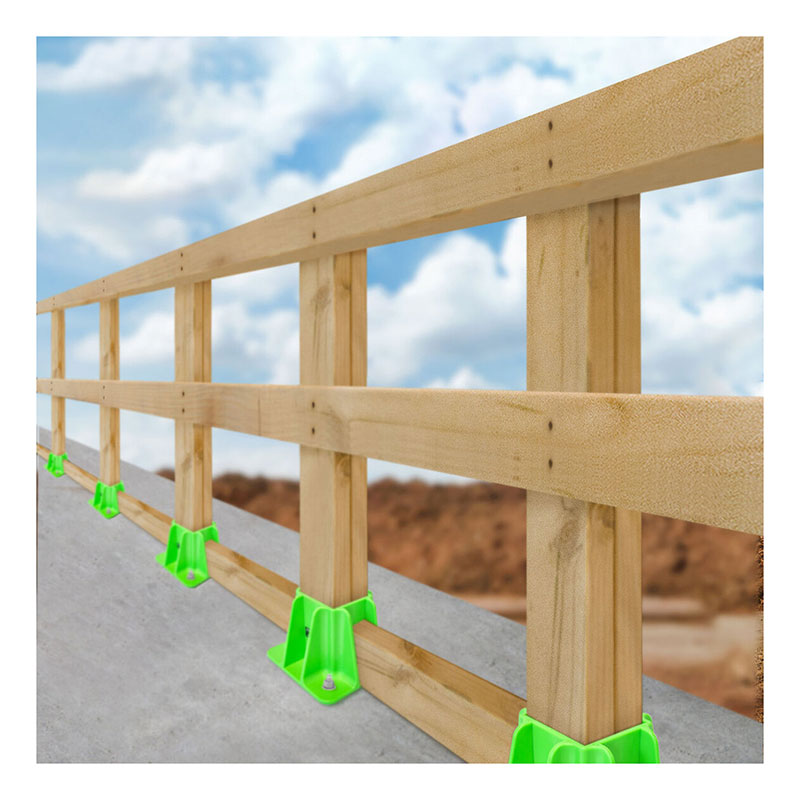 A wooden safety guardrail, supported by Frontline Fall Protection’s Frontline Safety Guardrail Boot Base w/Hardware GPB200 units, is installed along a concrete edge under a blue sky and clouds for effective perimeter protection.