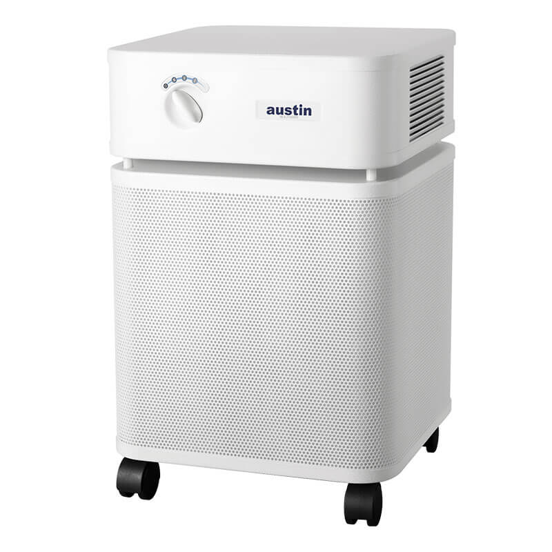 The Austin Air Systems HealthMate Plus Machine B450 is a white, box-shaped air purifier on four black wheels, with vented panels and a perforated base. It features medical grade HEPA filtration and removes formaldehyde for cleaner air.