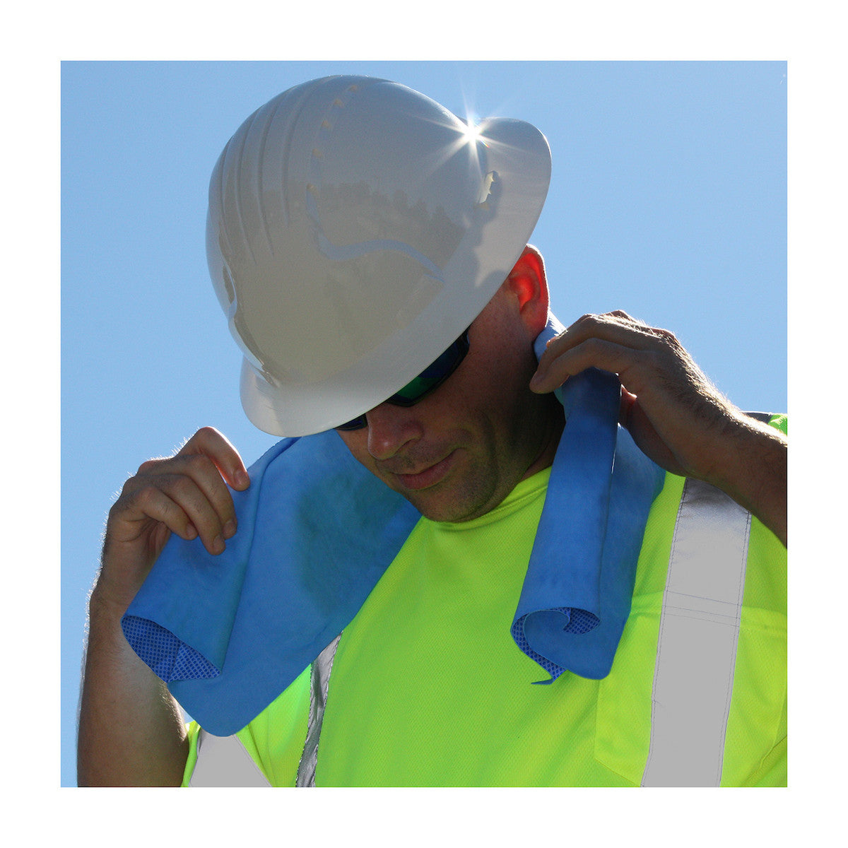 Man with blue towel around his neck wearing hard hat and hi-vis shirt.