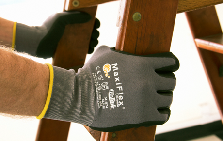 Person wearing MaxiFlex gloves while holding the side of a ladder.