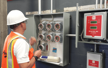 Worker looks at fixed gas detection from RKI Instruments