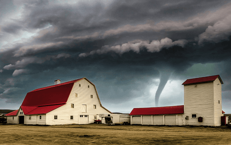 Tornado heading to a home with red roof in a rural area.