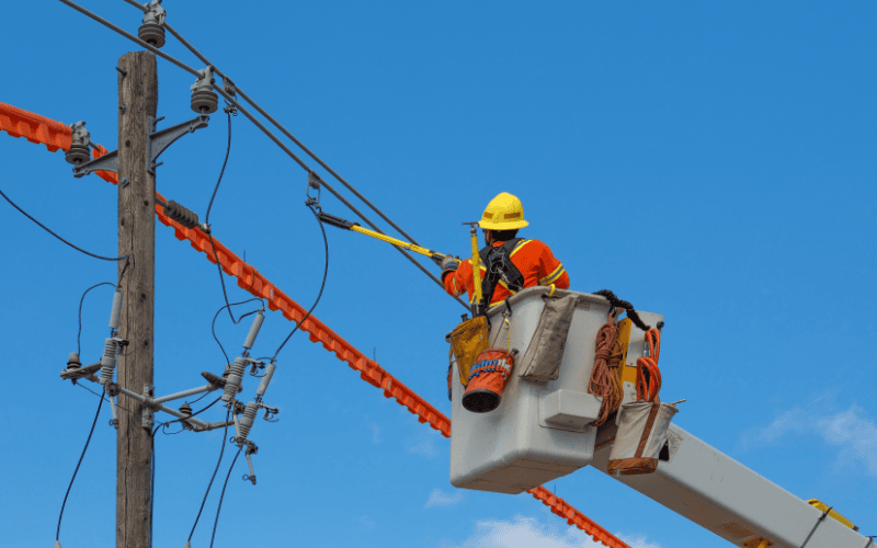 Utility worker fixing power lines.