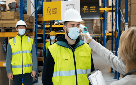Group of Workers with Face Mask in Warehouse, Coronavirus and Temperature Measuring Concept.