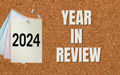 Year 2024 on paper pinned to cork board with words "Year in Review"