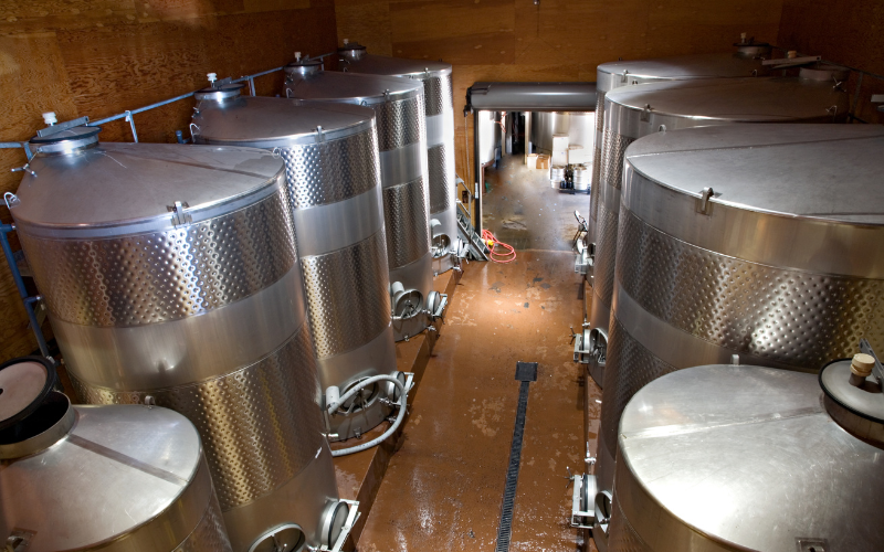 Downward view of multiple wine vats.