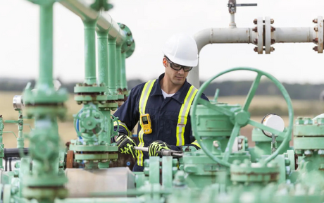 Worker wearing portable gas detector.