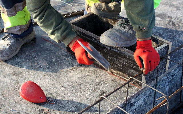 Construction worker wearing safety gloves.