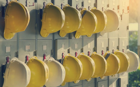 Rows of safety hard hats hanging.