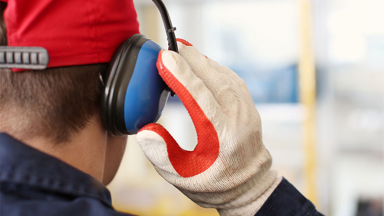 Worker wearing earmuffs as hearing protection.