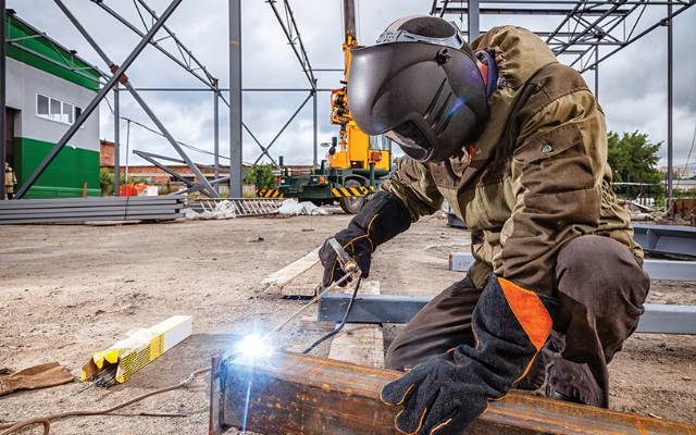 Welder wearing Arc Flash workwear while sparks are flying.