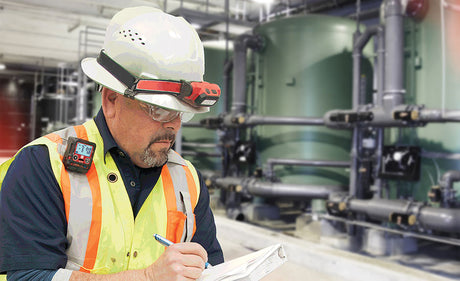 Worker wearing a portable gas detector.